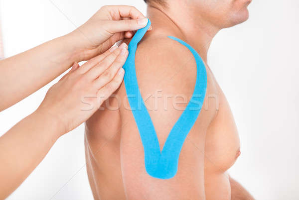 Person Applying Physio Tape To Man Stock photo © AndreyPopov