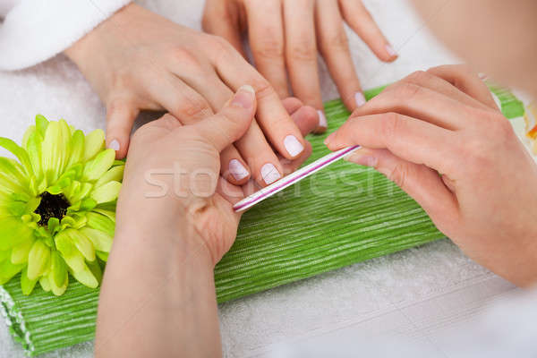 Beautician Filing Nails Of Woman Stock photo © AndreyPopov