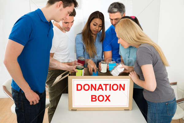 People Looking Inside Donation Box Stock photo © AndreyPopov