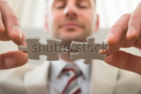 Businessman Connecting Together Puzzle Stock photo © AndreyPopov