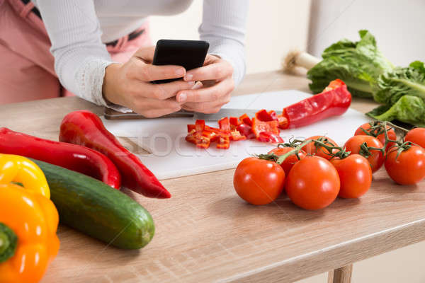 Woman With Mobile Phone And Vegetables Stock photo © AndreyPopov