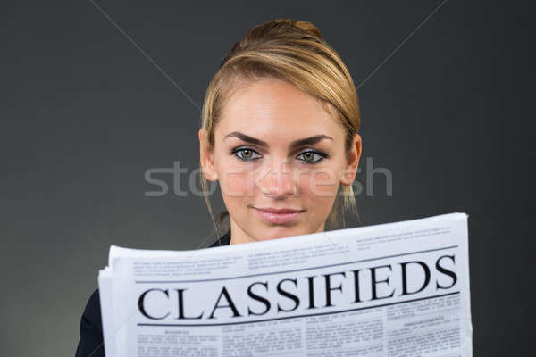 Smiling Businesswoman Reading Newspaper Stock photo © AndreyPopov