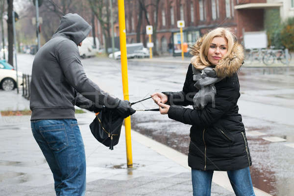 Robber Pulling Purse From Woman On Sidewalk Stock photo © AndreyPopov