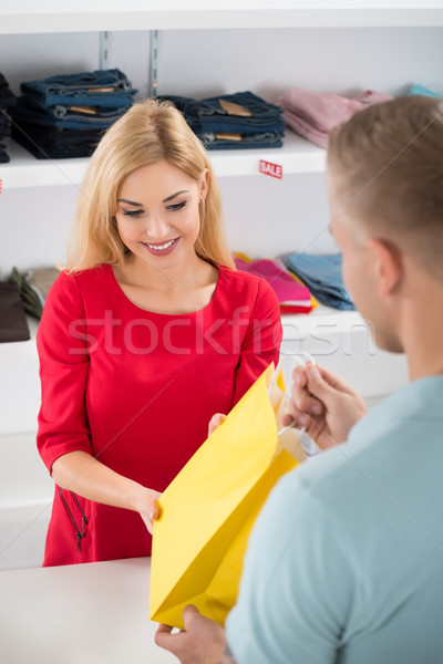 Happy Saleswoman Giving Shopping Bag To Customer Stock photo © AndreyPopov