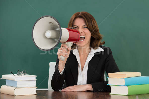 Female Teacher Shouting Through Megaphone Stock photo © AndreyPopov