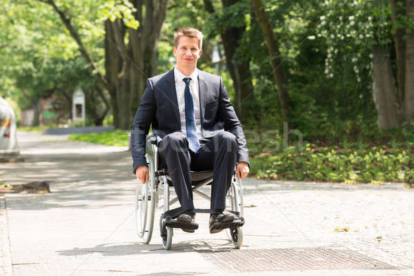 Młodych niepełnosprawnych człowiek wózek portret szczęśliwy Zdjęcia stock © AndreyPopov