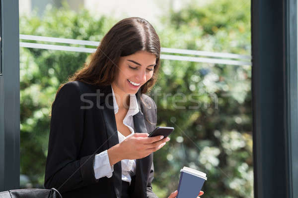 Happy Businesswoman Using Cellphone Stock photo © AndreyPopov