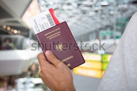 Hand Holding Passport And Boarding Pass Stock photo © AndreyPopov
