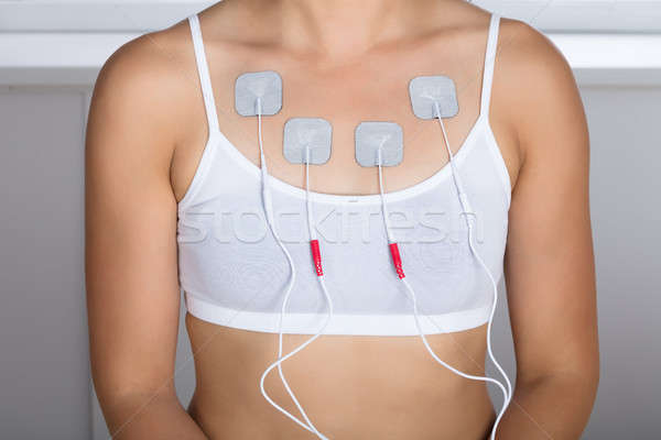 Woman Having Electrotherapy On Chest Stock photo © AndreyPopov