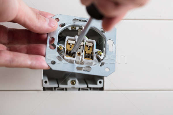 Person's Hand Repairing Electrical Socket Stock photo © AndreyPopov