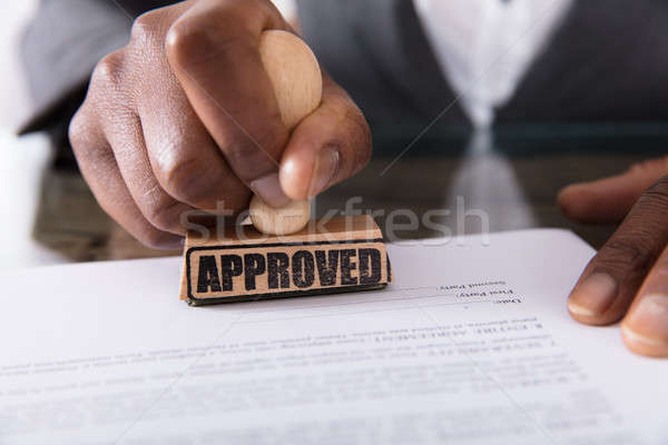 Person's Hand Stamping On Approved Contract Form Stock photo © AndreyPopov