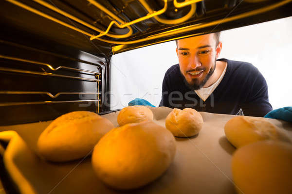 Man Taking Out Tray Of Baked Cookies From Oven Stock photo © AndreyPopov