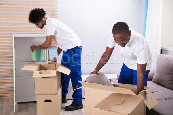 Movers Unpacking The Cardboard Boxes In The Home Stock photo © AndreyPopov