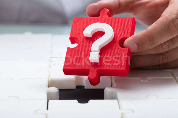 Person placing question mark piece into jigsaw puzzle Stock photo © AndreyPopov