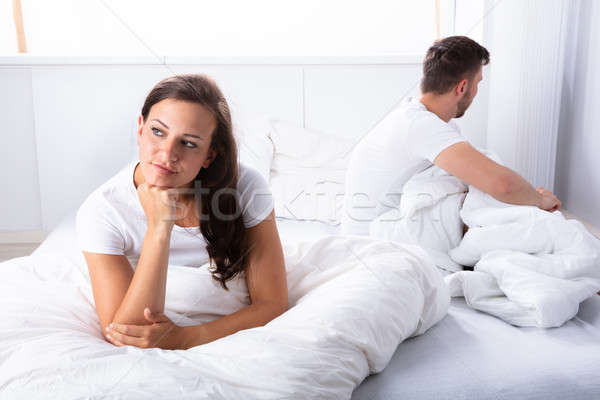 Stock photo: Unhappy Couple Sitting On Bed