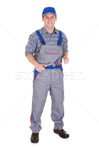 Happy male mechanic holding ratchet Stock photo © AndreyPopov