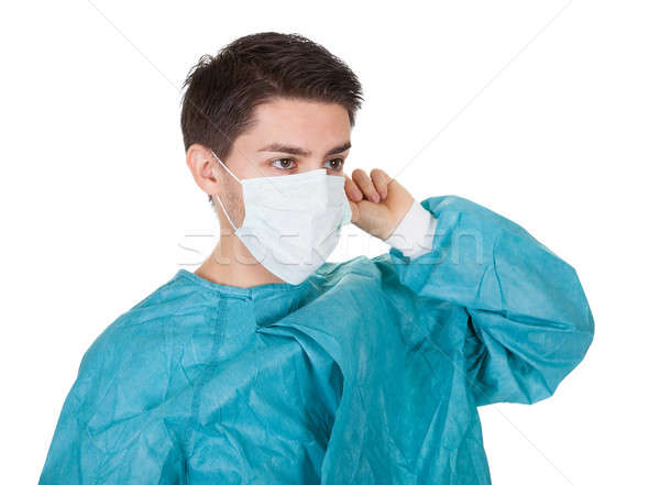 Sorridente jovem cirurgião vestido isolado Foto stock © AndreyPopov