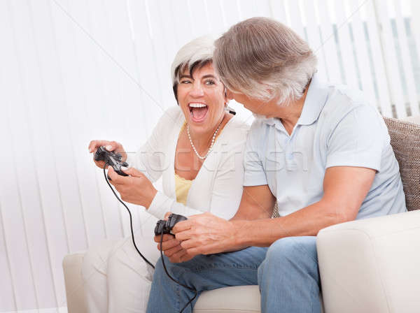 Middle-aged couple playing computer games Stock photo © AndreyPopov