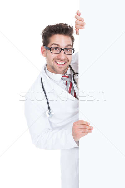 Stock photo: Happy Male Doctor Displaying Billboard