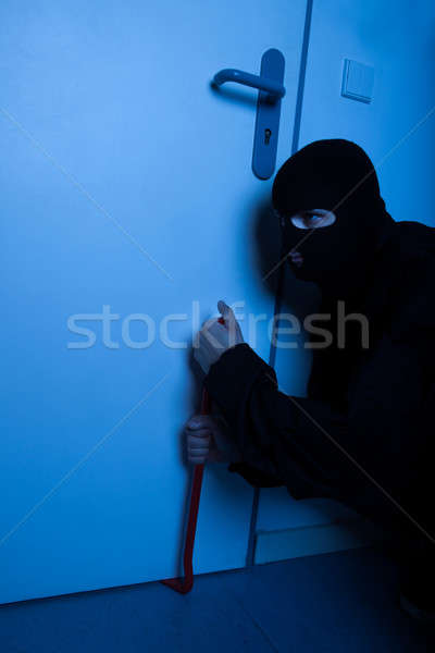 Thief Opening House Door With Crowbar Stock photo © AndreyPopov