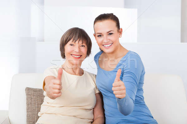 Caregiver And Senior Woman Showing Thumbs Up Stock photo © AndreyPopov