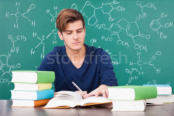 [[stock_photo]]: Jeune · homme · étudier · portrait · chimie · livre · livres