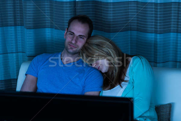 пару диван Смотря телевизор сидят домой женщину Сток-фото © AndreyPopov
