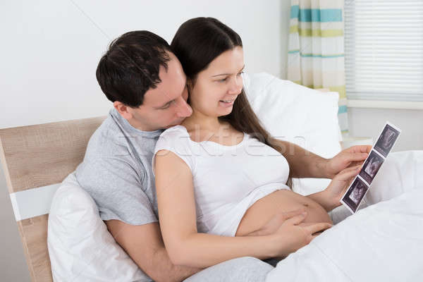 Couple Looking At Ultrasound Scan Of Their Expecting Baby Stock photo © AndreyPopov