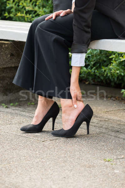 Businesswoman's Hand Removing High Heels Stock photo © AndreyPopov