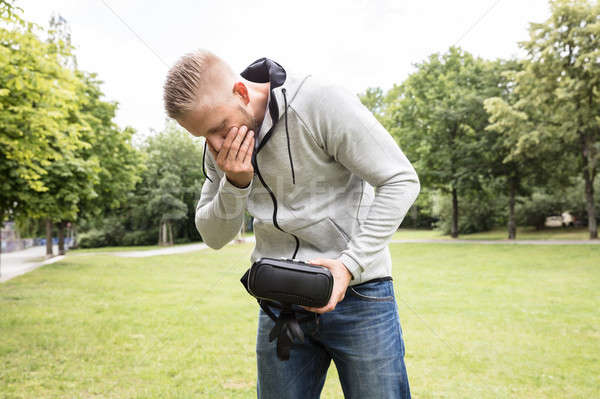 Man With Nausea Holding Virtual Reality Headset Stock photo © AndreyPopov