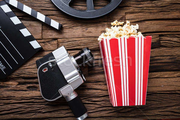 Movie Camera With Clapper Board And Popcorn On Wood Stock photo © AndreyPopov