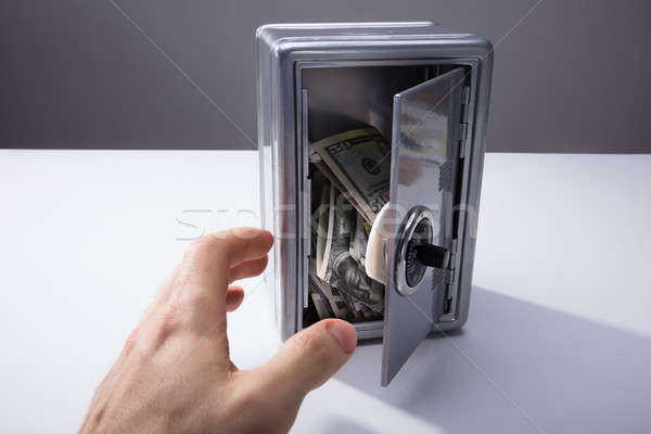 Person Taking Banknotes From Open Safe Stock photo © AndreyPopov