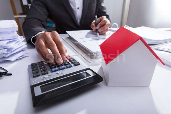 Businessperson Calculating Bill In Office Stock photo © AndreyPopov