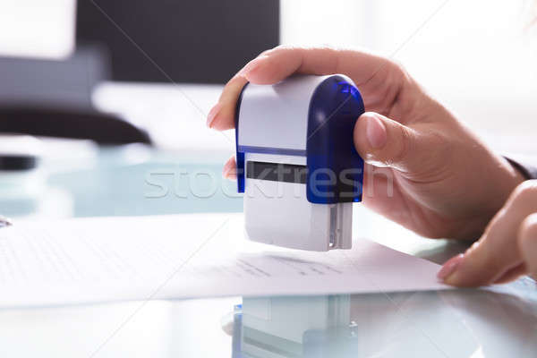 Close-up Of A Businessperson Stamping Document Stock photo © AndreyPopov