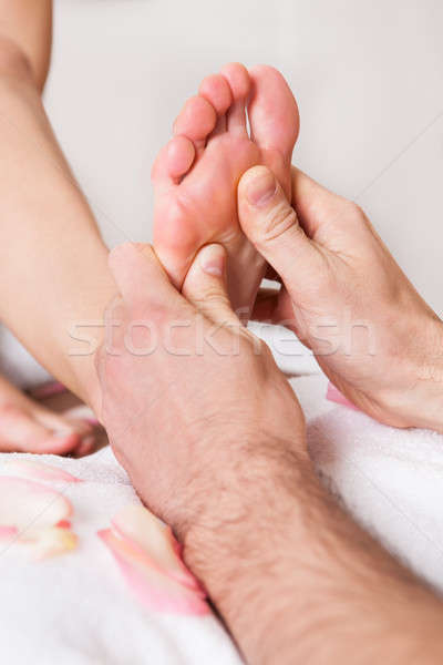Beautiful young woman getting feet massage Stock photo © AndreyPopov