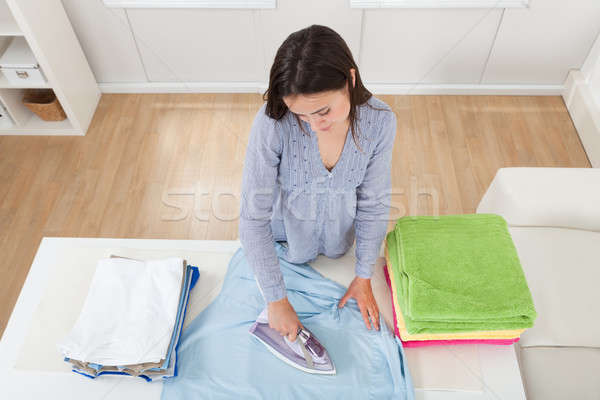 Woman Ironing Clothes In House Stock photo © AndreyPopov