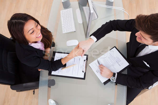 Business People Shaking Hands At Desk Stock photo © AndreyPopov