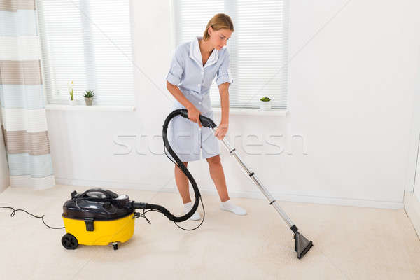 Female Maid Vacuuming Floor Stock photo © AndreyPopov