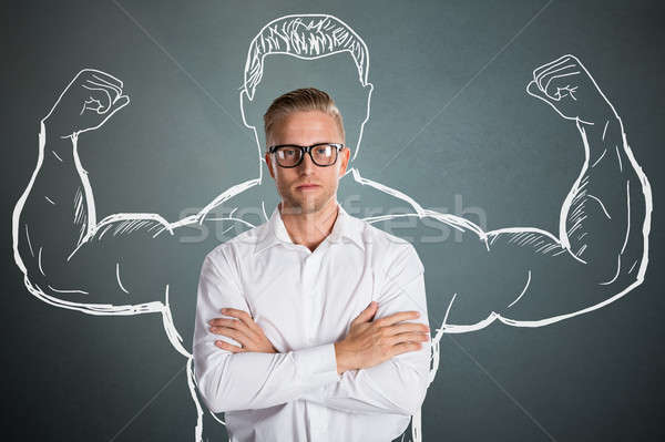 Jóvenes empresario brazo músculos dibujo pie Foto stock © AndreyPopov