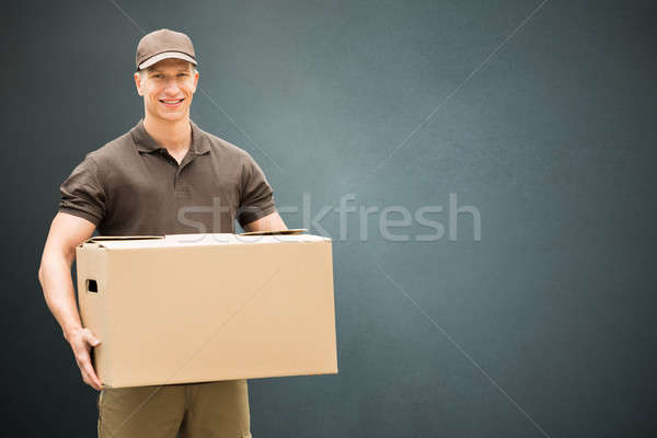 Delivery Man Holding Cardboard Box Stock photo © AndreyPopov