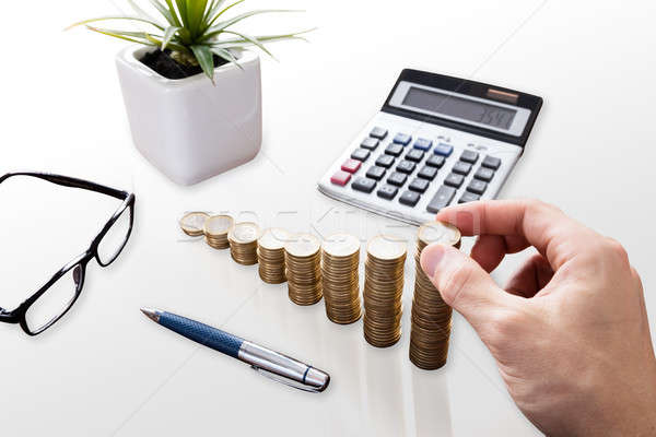 Close-up Of A Businessperson Stacking Coins Stock photo © AndreyPopov