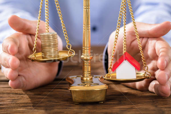 Person Protecting Justice Scale With Coins And House Model Stock photo © AndreyPopov