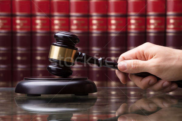 Person Striking Gavel On Sounding Block Stock photo © AndreyPopov