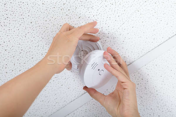 Person's Hand Installing Smoke Detector On Ceiling Stock photo © AndreyPopov