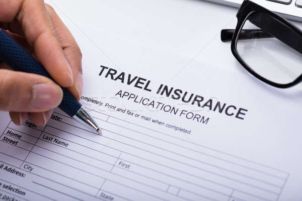 Person Filling Travel Insurance Form Stock photo © AndreyPopov