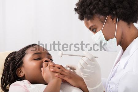 Woman Undergoing Dental Treatment Stock photo © AndreyPopov