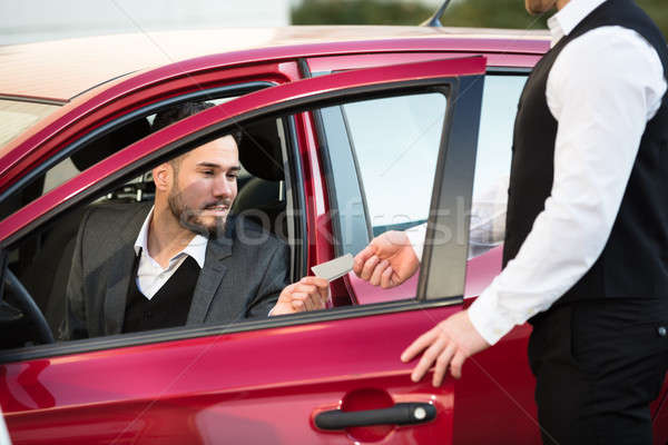 Valet Giving Receipt To Businessperson Sitting Inside Car Stock photo © AndreyPopov