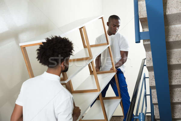 Two Male Movers Carrying The Empty Shelf At Home Stock photo © AndreyPopov