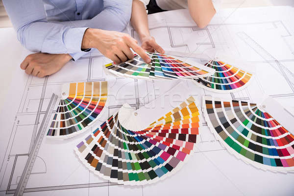 Close-up Of Two Architect Holding Colorful Swatch Over Blueprint Stock photo © AndreyPopov