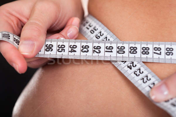 Young Woman Measuring Her Waist Stock photo © AndreyPopov